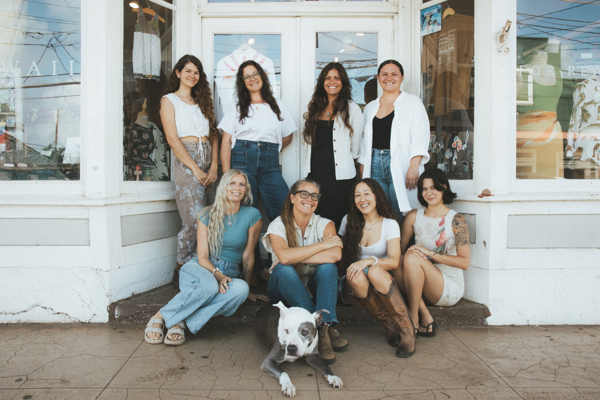 The Wings team on the step of the Paia shop, with the shop dog