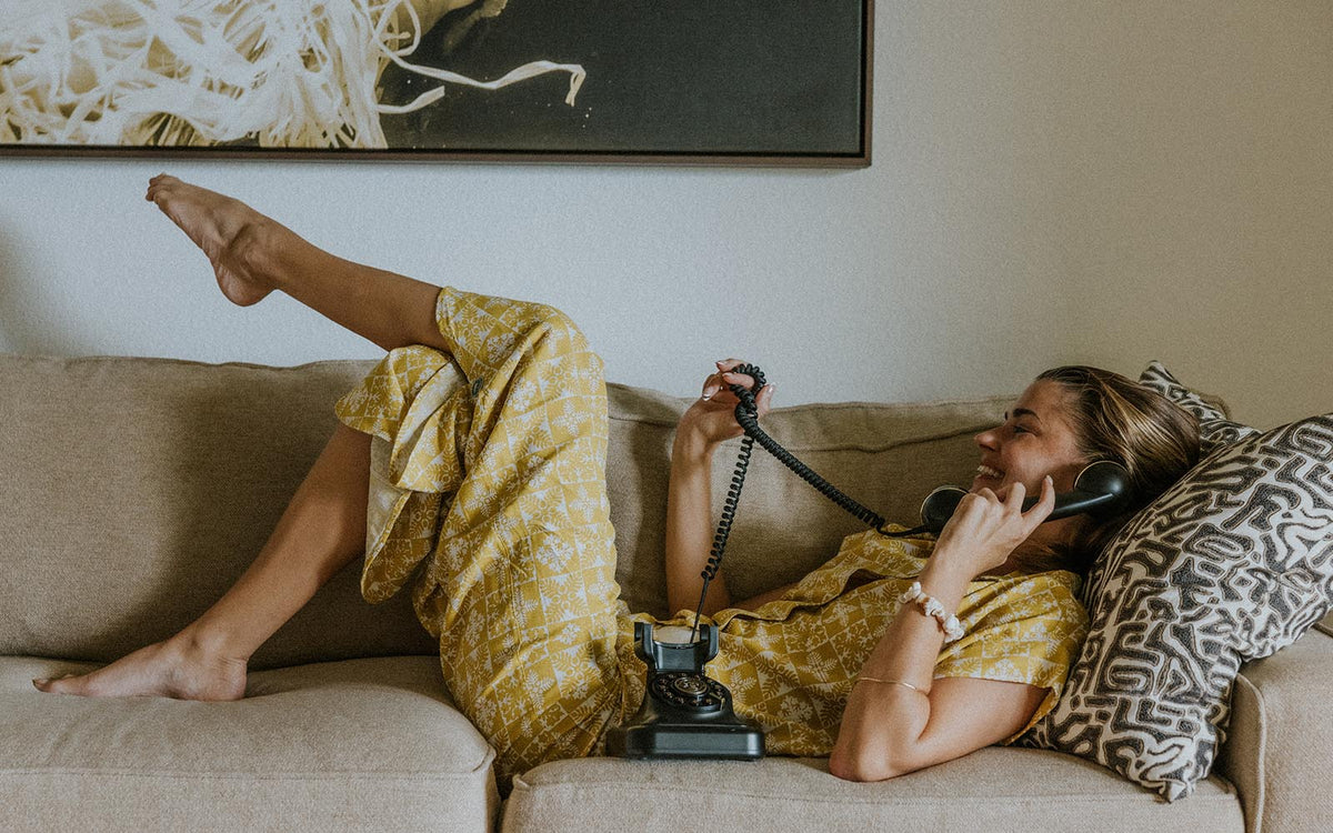 Model in a yellow set lying on a sofa