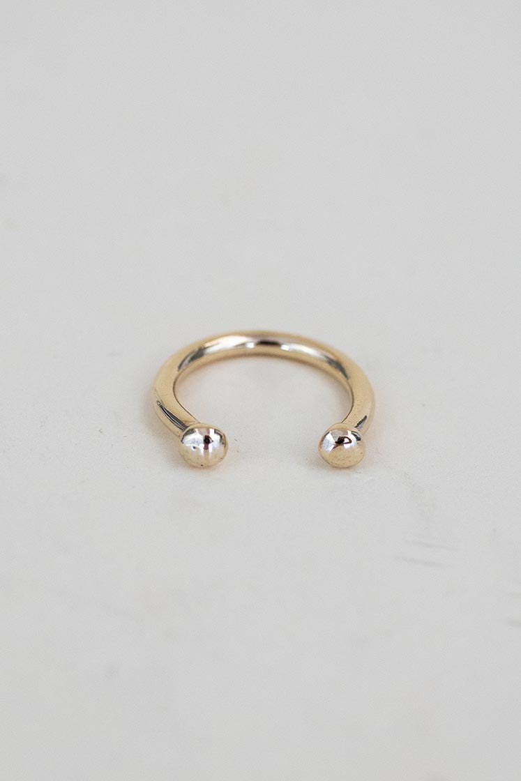 A Womens ring in the shape of a horse shoe