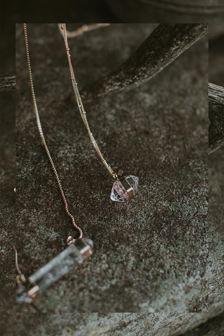 Banded herkimer dangling on a delicate chain necklace