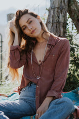 model wearing long beaded crystal necklace, lariat necklace with a sunstone and purple button up blouse and jeans thumbnail