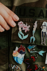 Wings Hawaii enamel pins on jacket thumbnail