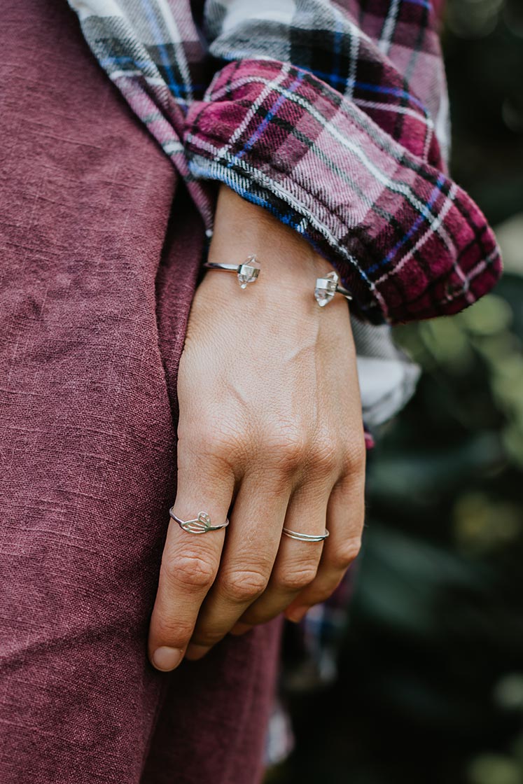 model wearing silver cuff bracelet with herkimer diamond stones and two silver rings