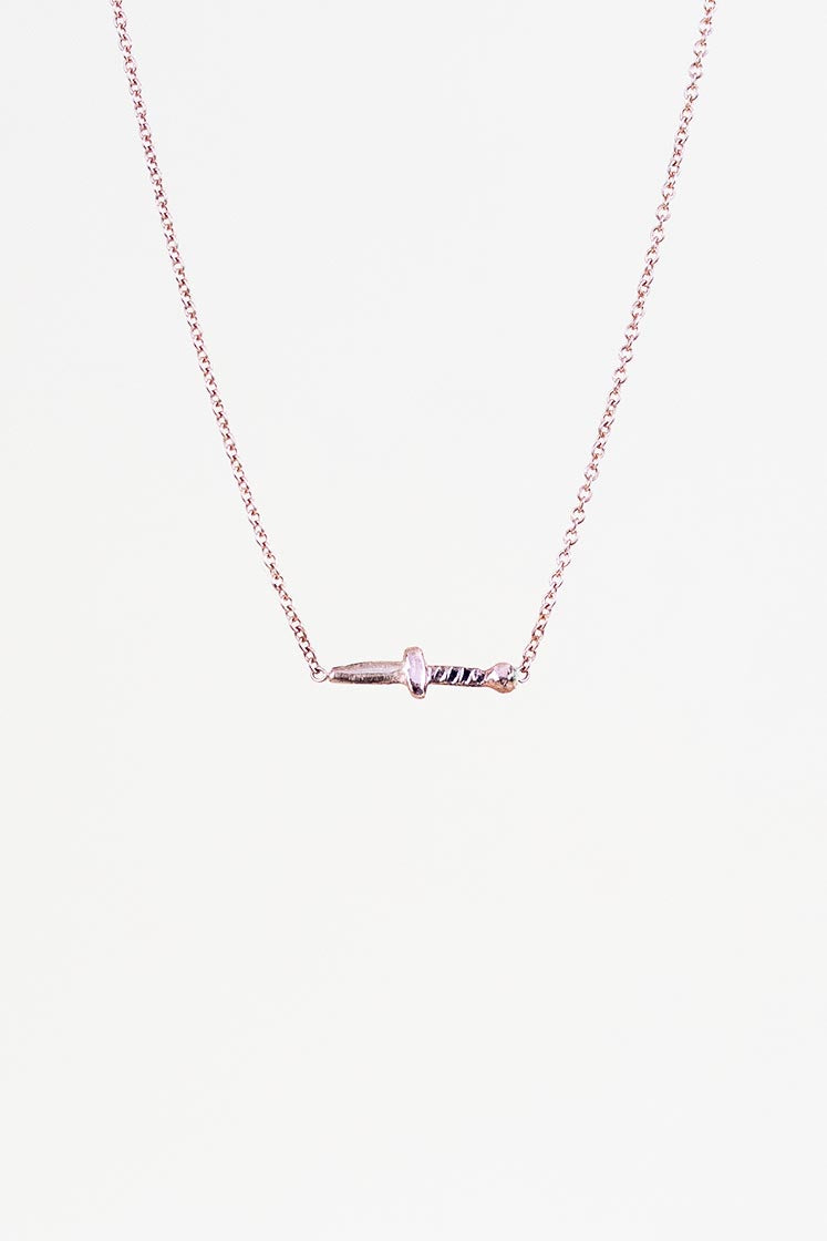 tiny dagger set in solid gold