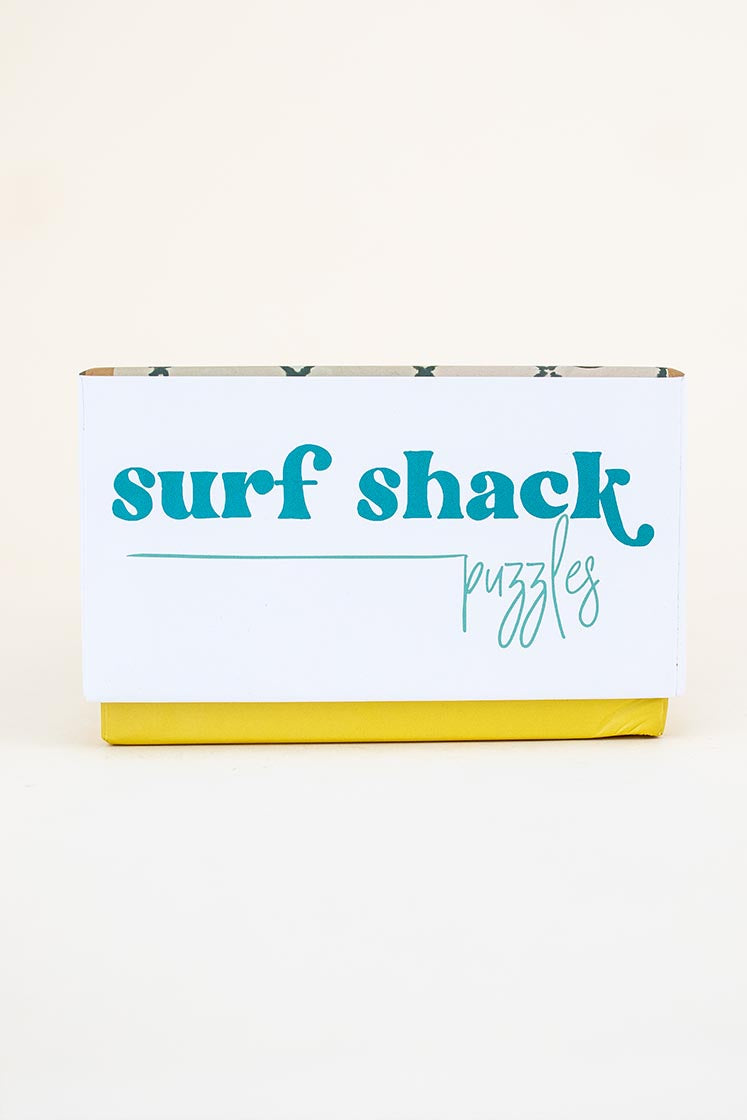 surf shack puzzle A super fun puzzle made of premium 100% recycled Eska board. Printed with non-toxic inks and a matte finish. Art by illustrator Kim Sielbeck based in Hawai'i. 